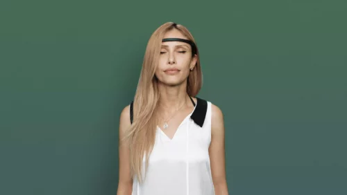A woman using a Muse headband to exercise the brain for optimal brain health - Zephyr Neuroscience